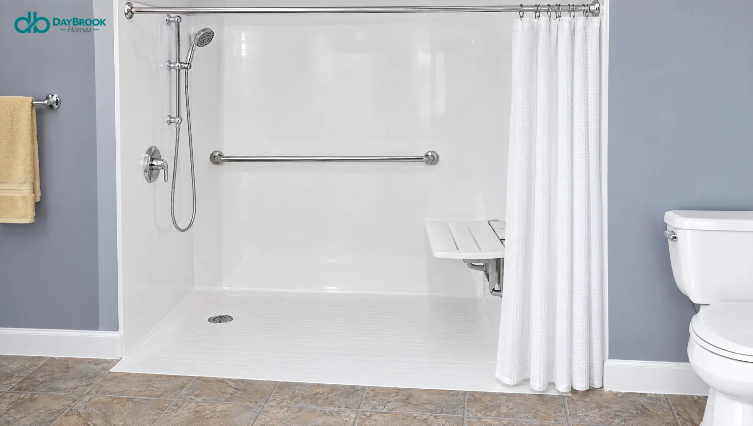 Barrier-free roll-in shower base with a fold-down seat, a grab bar, a handheld shower and a curtain